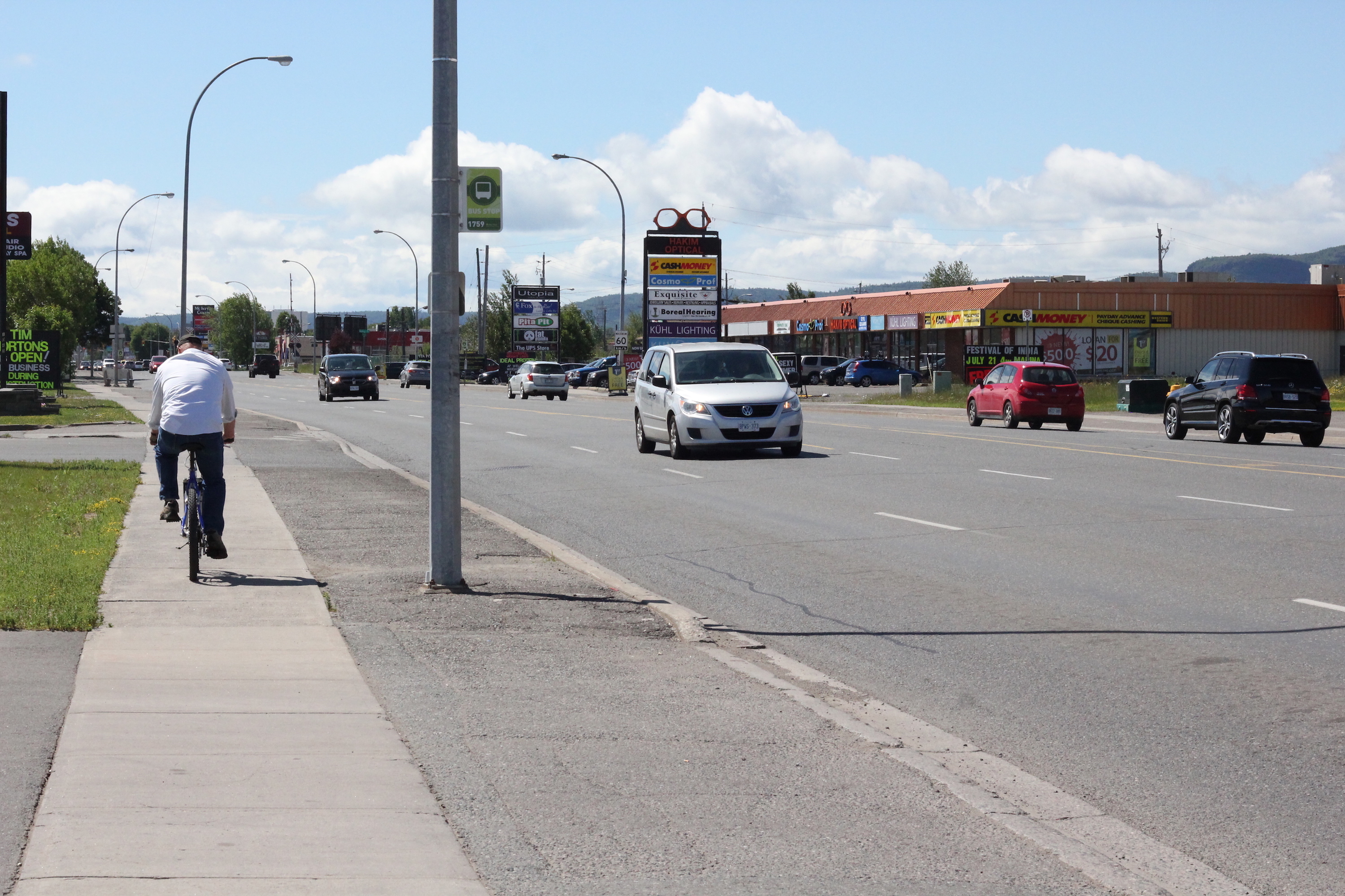 A man rides his bike on the sidewalk southbound on Memorial Avenue