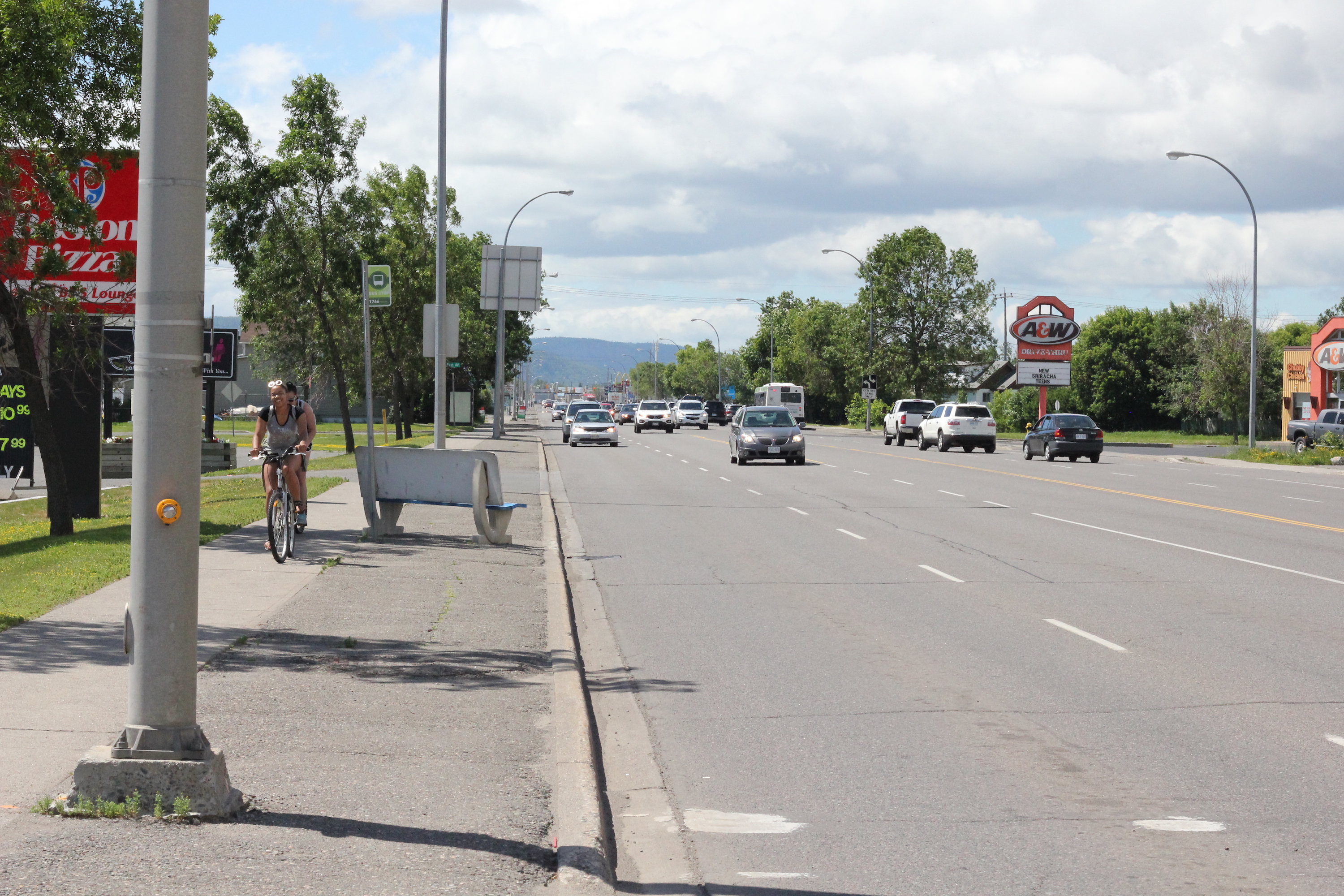 Biking on the sidewalk of Memorial Ave near the Thunder Bay Community Auditorium